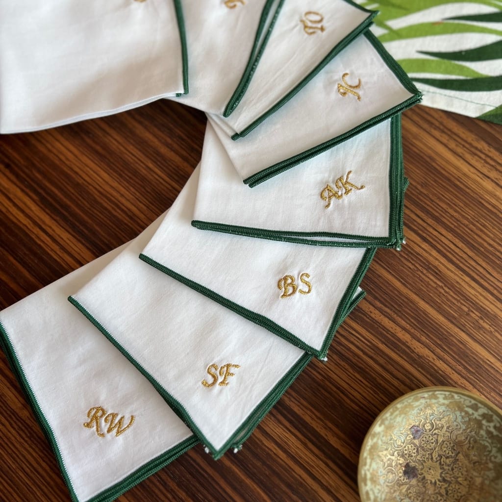green hemmed handkerchief with gold embroidered monogram