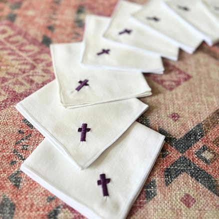 white handkerchief with purple embroidered cross