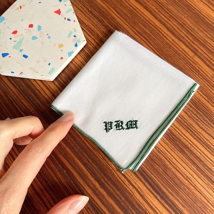 white handkerchief with forrest green hem and personalized embroidery